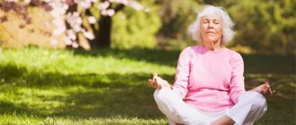 An elderly woman meditates in nature under sakura