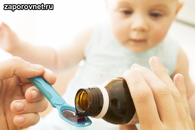 Medicine is poured into a spoon for a child