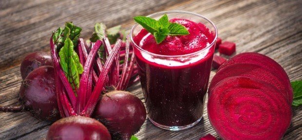 Beet juice in glasses and beets