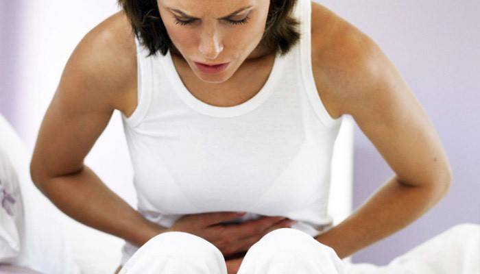 A woman has a stomach ache due to the presence of parasites