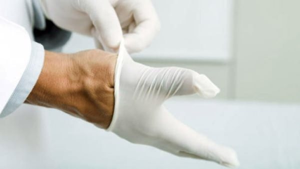 Proctologist puts on gloves