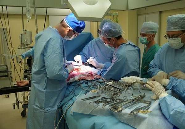 Doctors perform abdominal surgery